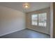 Bright bedroom with large window and grey flooring at 9538 Highland Ridge Dr, Hudson, FL 34667