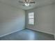 Simple bedroom with window and grey flooring at 9538 Highland Ridge Dr, Hudson, FL 34667