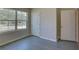 Well-lit bedroom featuring a window and grey flooring at 9538 Highland Ridge Dr, Hudson, FL 34667