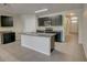 Modern kitchen with dark cabinets, granite countertops, and island at 9538 Highland Ridge Dr, Hudson, FL 34667