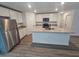 Bright kitchen featuring an island with a sink, granite countertops, and stainless steel appliances at 3769 S Haberland Blvd, North Port, FL 34288