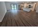 Open-concept living space featuring a kitchen with island, stainless steel appliances, and sliding glass door at 3769 S Haberland Blvd, North Port, FL 34288