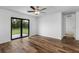 Bedroom with wood-look floors and sliding glass doors to backyard at 5473 Colfax Ter, Port Charlotte, FL 33981