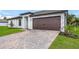 Modern house exterior with a paved driveway at 5473 Colfax Ter, Port Charlotte, FL 33981