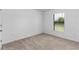 Bright bedroom with carpeted floor and large window at 5473 Colfax Ter, Port Charlotte, FL 33981