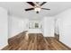 Spacious living room with wood-look floors and ceiling fan at 5473 Colfax Ter, Port Charlotte, FL 33981