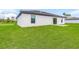 Rear view of modern house with grassy backyard at 5473 Colfax Ter, Port Charlotte, FL 33981