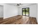 Bedroom with wood-look floors and sliding glass doors to patio at 5473 Colfax Ter, Port Charlotte, FL 33981