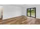 Bedroom with sliding glass doors to backyard and wood flooring at 12564 Feldman Ave, Port Charlotte, FL 33981