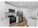 Kitchen with white cabinets, granite countertops, and stainless steel appliances at 12564 Feldman Ave, Port Charlotte, FL 33981