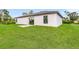 View of the back of the house, showing a patio and grassy backyard at 12564 Feldman Ave, Port Charlotte, FL 33981