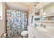 Bathroom with white vanity, shower, and ocean-themed decor at 1402 Viscaya Dr, Port Charlotte, FL 33952