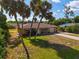 Aerial view of yellow house with palm trees and driveway at 1402 Viscaya Dr, Port Charlotte, FL 33952