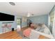 Bright living room with hardwood floors, comfy sectional sofa, and large TV at 1402 Viscaya Dr, Port Charlotte, FL 33952