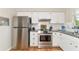 Kitchen boasts stainless steel appliances and white cabinetry at 1402 Viscaya Dr, Port Charlotte, FL 33952
