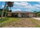 Single story home with attached garage and palm trees at 1402 Viscaya Dr, Port Charlotte, FL 33952