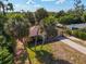 Aerial view of yellow house with palm trees and driveway at 1402 Viscaya Dr, Port Charlotte, FL 33952
