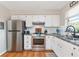 Kitchen with stainless steel appliances and white cabinetry at 1402 Viscaya Dr, Port Charlotte, FL 33952