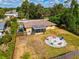 Aerial view showing house, backyard with firepit, and surrounding area at 1402 Viscaya Dr, Port Charlotte, FL 33952