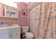 Bathroom with pink walls, shower, and vanity at 1402 Viscaya Dr, Port Charlotte, FL 33952