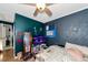 Small bedroom with teal and gray walls, a bed, and a TV at 1402 Viscaya Dr, Port Charlotte, FL 33952
