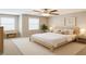 This staged bedroom features a neutral color scheme, two large windows, and modern decor at 10957 Keys Gate Dr, Riverview, FL 33579