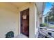 Front door with decorative basket, potted plant, and stone accents at 10957 Keys Gate Dr, Riverview, FL 33579