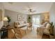 This open concept living room has wood floors, neutral walls, lots of light, and modern furniture at 10957 Keys Gate Dr, Riverview, FL 33579