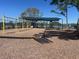 Playground area with covered play area, swings, slides, climbing area and picnic tables at 10957 Keys Gate Dr, Riverview, FL 33579
