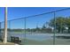 Outdoor tennis court with fence, benches, and well-maintained playing surface at 10957 Keys Gate Dr, Riverview, FL 33579