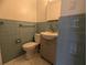 Bright bathroom with blue tiles, modern sink and ample lighting at 3931 E Eden Roc Cir, Tampa, FL 33634