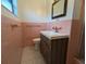 Pink tiled bathroom features a modern vanity and updated fixtures at 3931 E Eden Roc Cir, Tampa, FL 33634