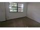 Bedroom with a large window and neutral carpet at 3931 E Eden Roc Cir, Tampa, FL 33634