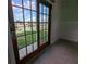 Bedroom view with sliding doors to the outside, showcasing a canal and green backyard at 3931 E Eden Roc Cir, Tampa, FL 33634