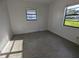 Bedroom with two windows providing ample natural light at 3931 E Eden Roc Cir, Tampa, FL 33634