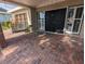 Inviting covered front porch with a swing, brick columns, and double front doors at 3931 E Eden Roc Cir, Tampa, FL 33634