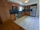 A spacious kitchen with stainless steel appliances and light wood cabinets at 3931 E Eden Roc Cir, Tampa, FL 33634