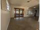 Spacious living room with a view of the outdoors through large windows and double doors at 3931 E Eden Roc Cir, Tampa, FL 33634