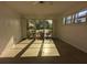 Sunny living room with large windows, filling the space with natural light and views of the yard at 3931 E Eden Roc Cir, Tampa, FL 33634