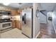 Kitchen with stainless steel appliances and light wood cabinets at 10957 Keys Gate Dr, Riverview, FL 33579