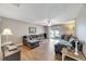 Spacious living room with L-shaped sectional sofa and wood floors at 10957 Keys Gate Dr, Riverview, FL 33579
