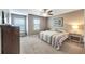Bedroom with striped bedding and wood furniture at 10957 Keys Gate Dr, Riverview, FL 33579