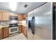 Stainless steel appliances and light wood cabinets in this kitchen at 10957 Keys Gate Dr, Riverview, FL 33579