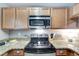 Modern electric cooktop and microwave in this stylish kitchen at 10957 Keys Gate Dr, Riverview, FL 33579