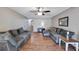 Living room with L-shaped sectional sofa and hardwood floors at 10957 Keys Gate Dr, Riverview, FL 33579