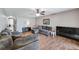 Living room with sectional sofa, hardwood floors, and large TV at 10957 Keys Gate Dr, Riverview, FL 33579