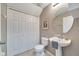 Small bathroom with pedestal sink and ample storage at 10957 Keys Gate Dr, Riverview, FL 33579