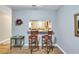 Breakfast bar with two stools looks into the kitchen area at 10957 Keys Gate Dr, Riverview, FL 33579