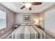 Spacious bedroom with striped bedding, ceiling fan, and ample closet space at 10957 Keys Gate Dr, Riverview, FL 33579