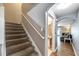 Carpeted staircase with simple railing leads to upper level at 10957 Keys Gate Dr, Riverview, FL 33579